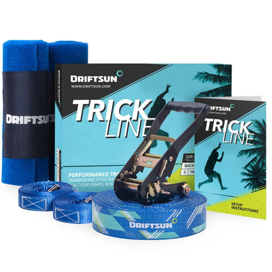 Complete Driftsun slackline trick line set layed out including the webbing, ratchet, tree guards, instruction manual, and packaging